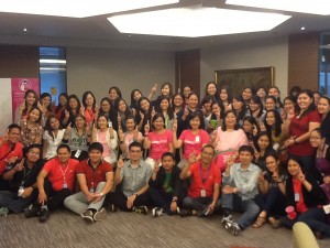 Del Monte staff members make the Pink Positive sign, together with ICanServe volunteers who delivered the company's Pink Positive Pledge Wall. (September 27, 2013)